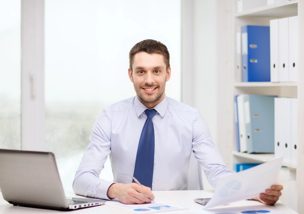 A businessman at desk with laptop