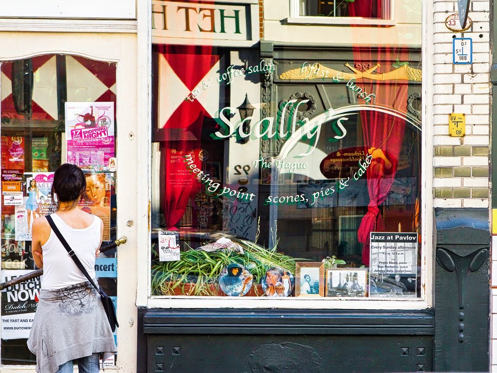 A woman stands outside Scallys.